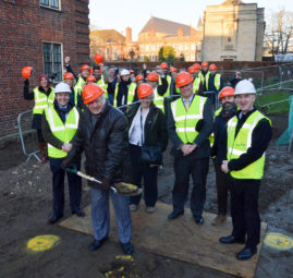 Dr. Trevor Hughes digs the first earth on the site of the new building which will be named after his late wife