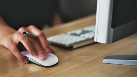 Person using an apple mouse. image by Vojtech Okenka